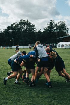 A rugby player tackling an opponent, illustrating the differences between rugby and football gameplay.