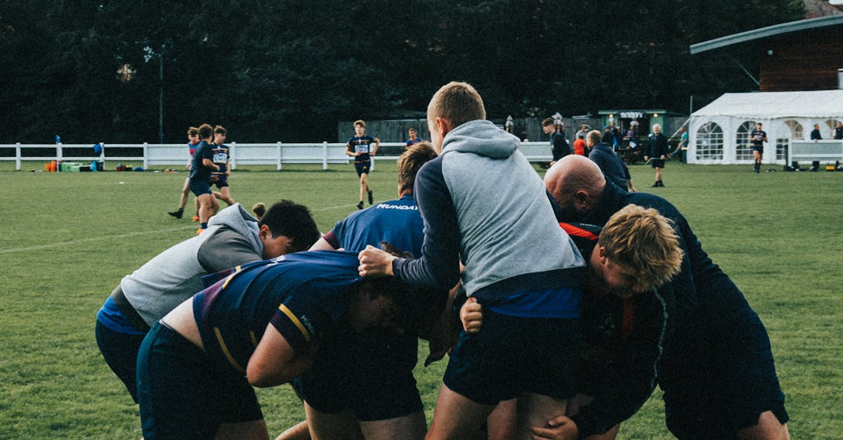 Group of Athletes playing Rugby on Green Grass Field · Free Stock Photo