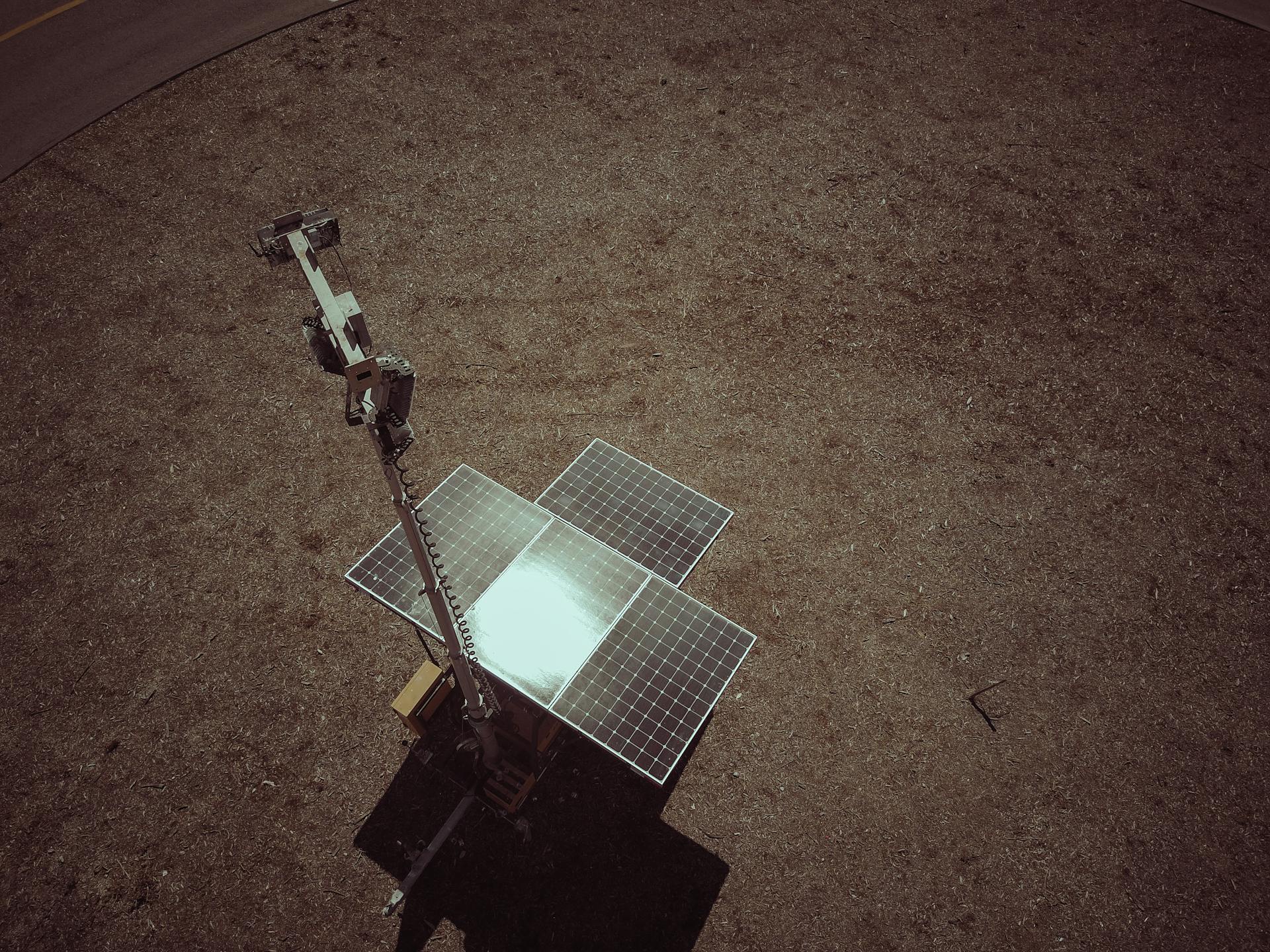 Drone view of solar panels on a dry and barren landscape emphasizing renewable energy.