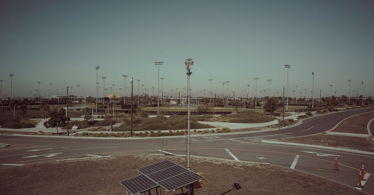 A mobile solar power unit in an open field area captures clean energy.