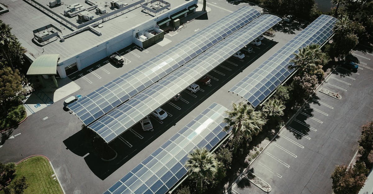 Aerial view of solar panels on a parking lot roof, showcasing renewable energy.