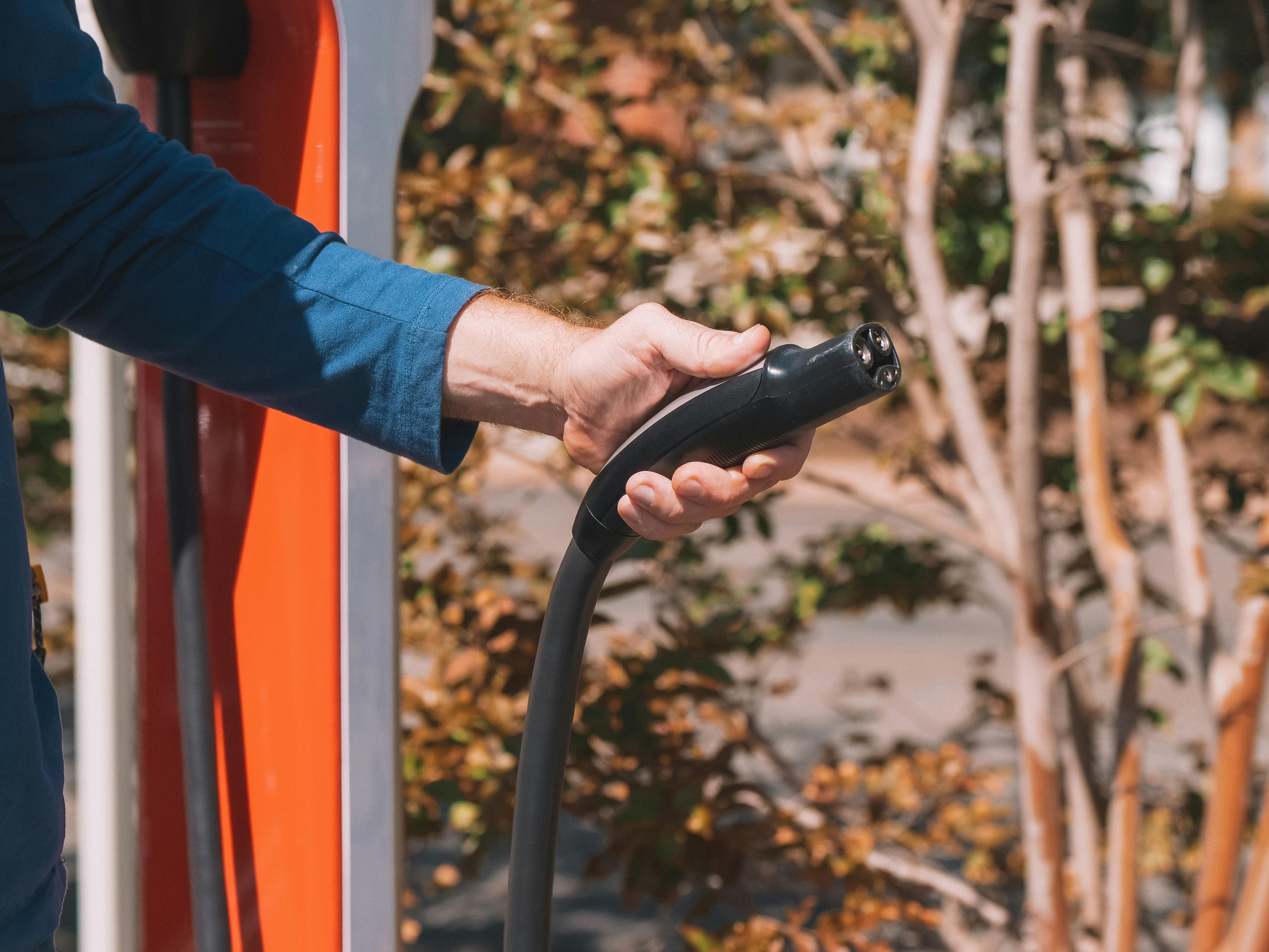 person holding black car steering wheel