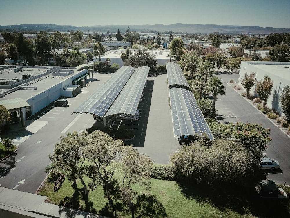Free Aerial shot of solar panel installations in a suburban neighborhood under clear skies. Stock Photo