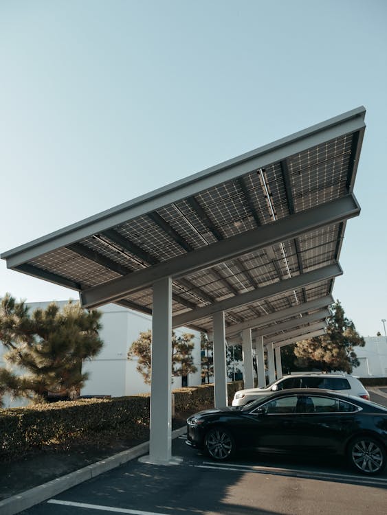 Free Cars Parked on Parking Lot Under the Solar Panels Stock Photo