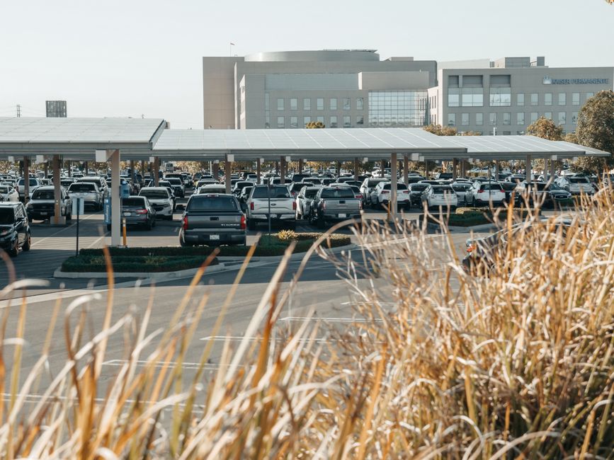 commercial parking lot in the United States with solar carports providing shade for vehicles - commercial solar panel installation commercial parking lot in the United States with solar carports providing shade for vehicles - commercial solar panel installation