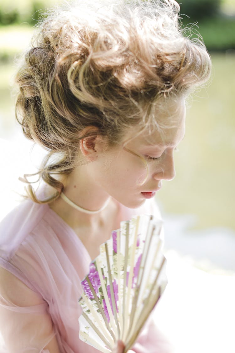 Beautiful Woman Holding A Fan