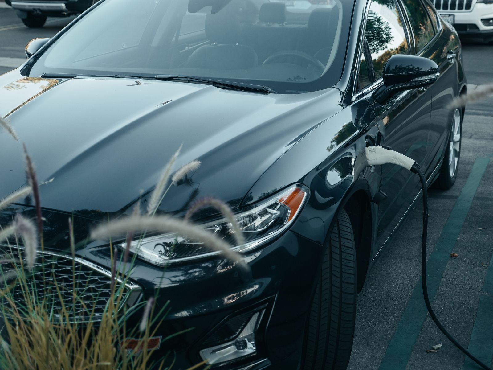 Electric vehicle parked in a marked public charging bay