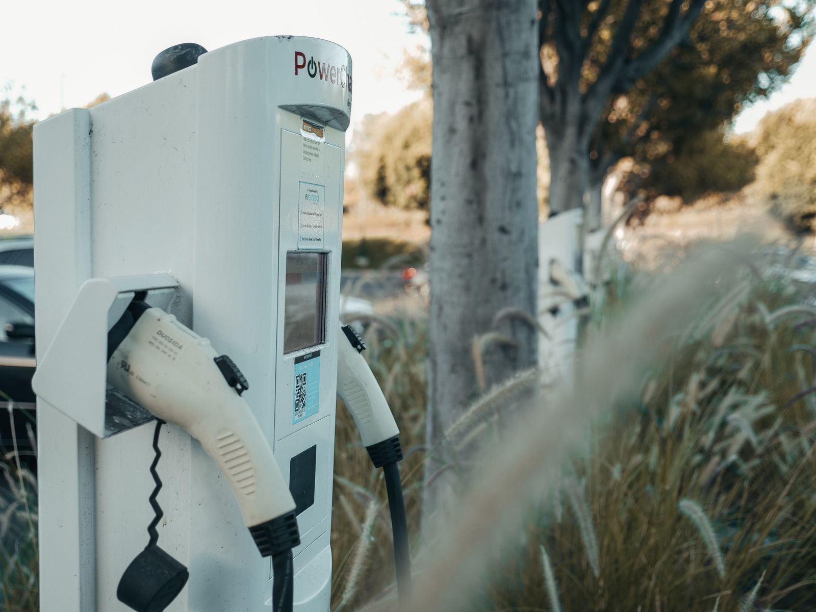 High-power public EV charger cables at an outdoor charging hub
