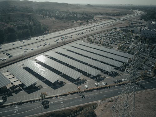 Free Solar Panel Farm Near a Highway Stock Photo
