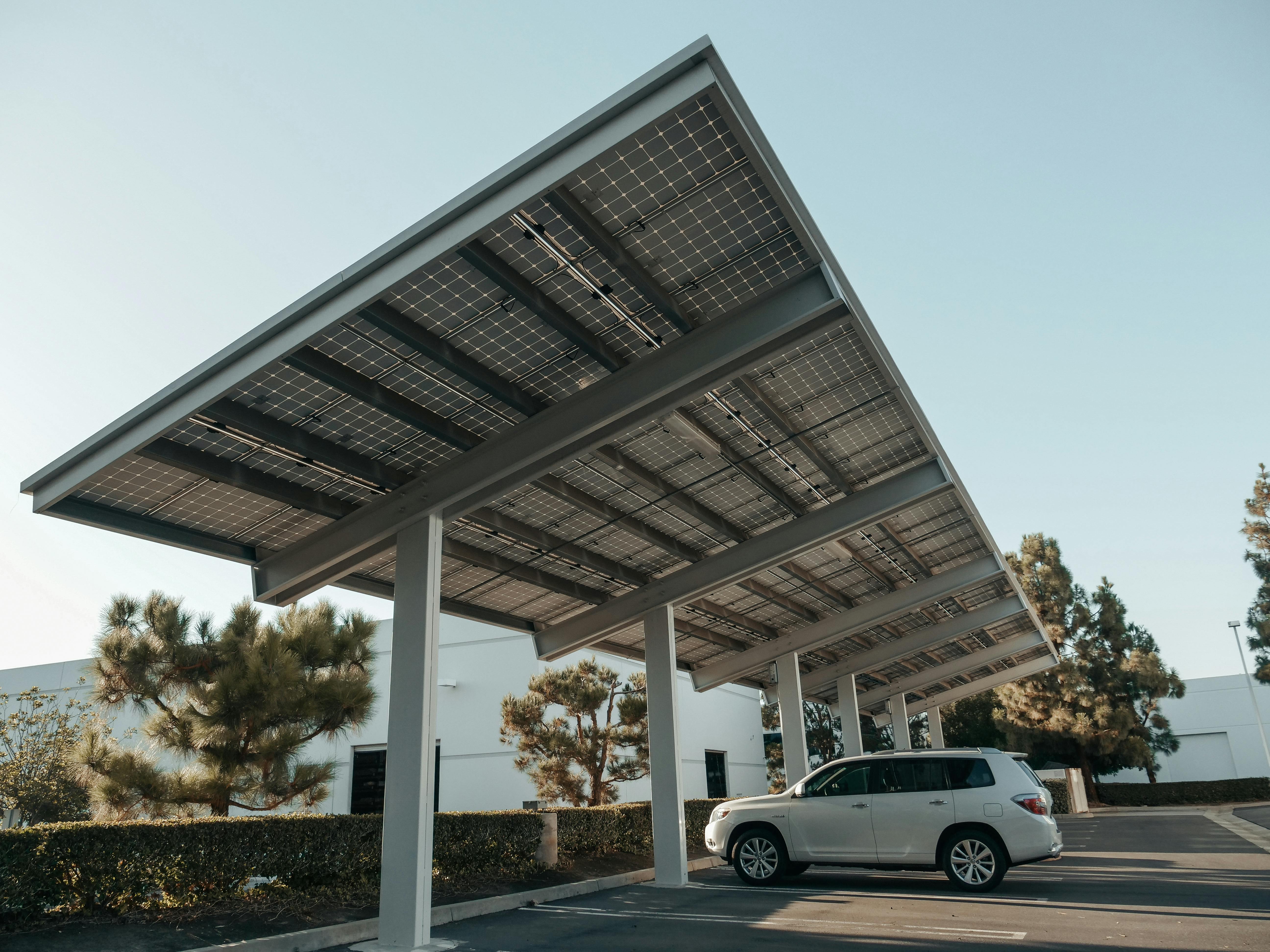 Free Solar panel carport in a modern urban setting, showcasing clean energy solutions. Stock Photo