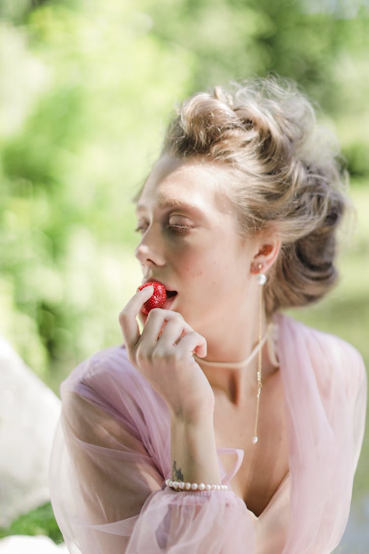 Woman Eating A Strawberry