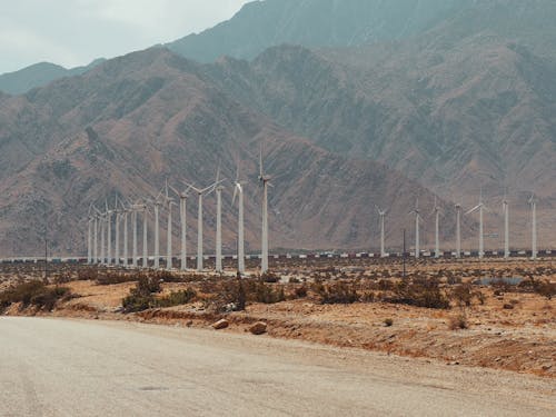 Windmills in a Windpark beside Mountains 