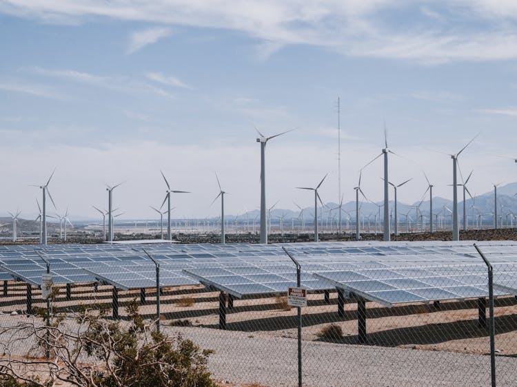 Wind Turbines And Solar Panels During Daytime 