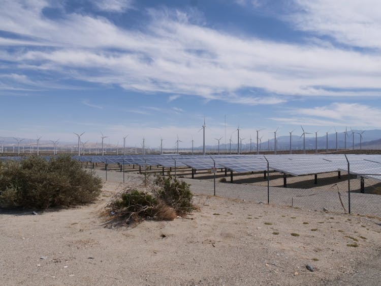 Wind Turbines And Solar Panels On The Countryside