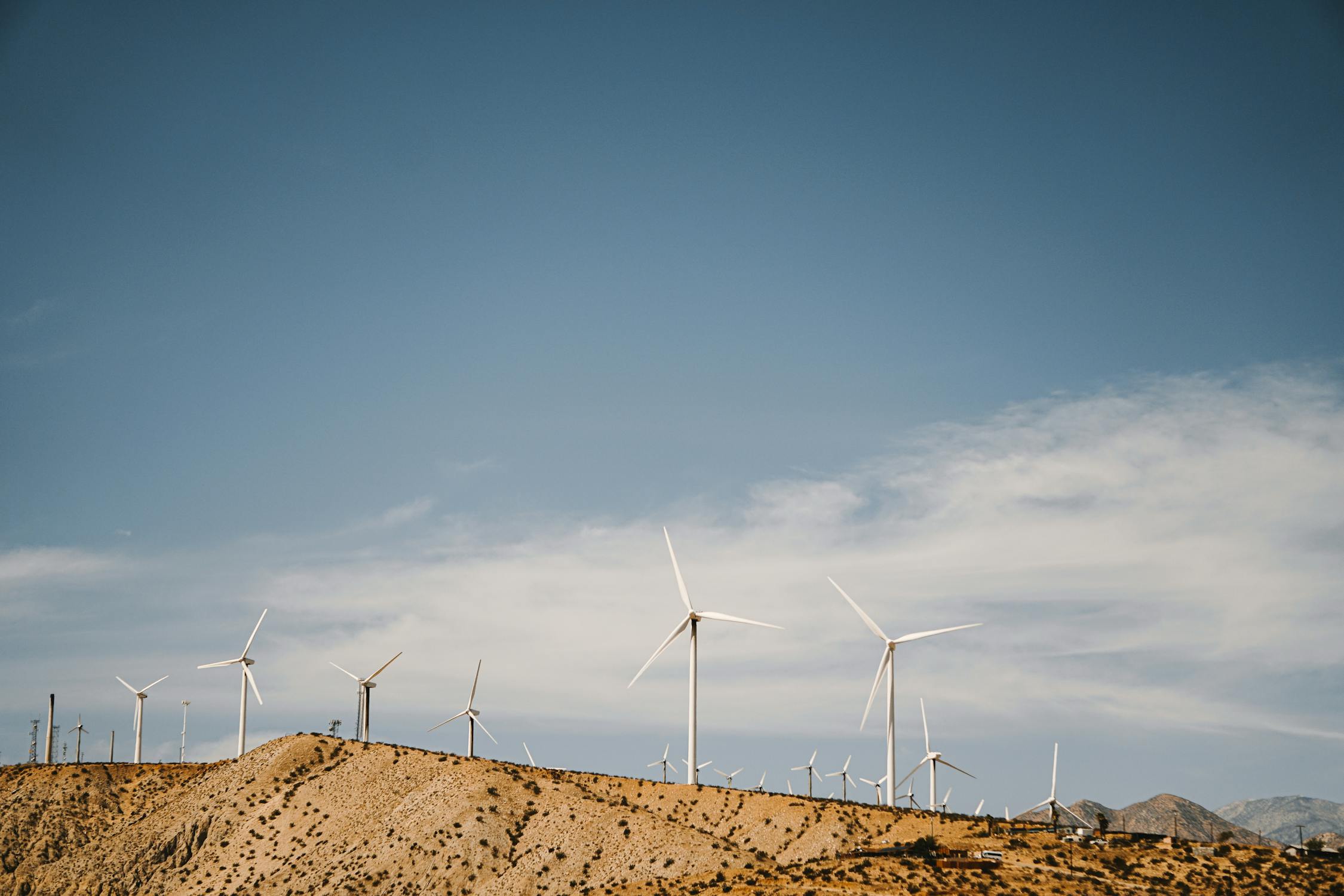A Wind Farm Under the Blue Sky - Pexels - Copyright: Kindel Media