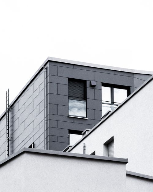 Free Low angle view of a modern building with concrete and glass elements. Stock Photo