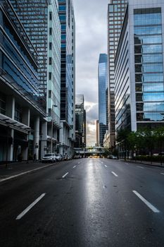 Stunning view of Calgary's skyscrapers lining a quiet downtown street at dusk.