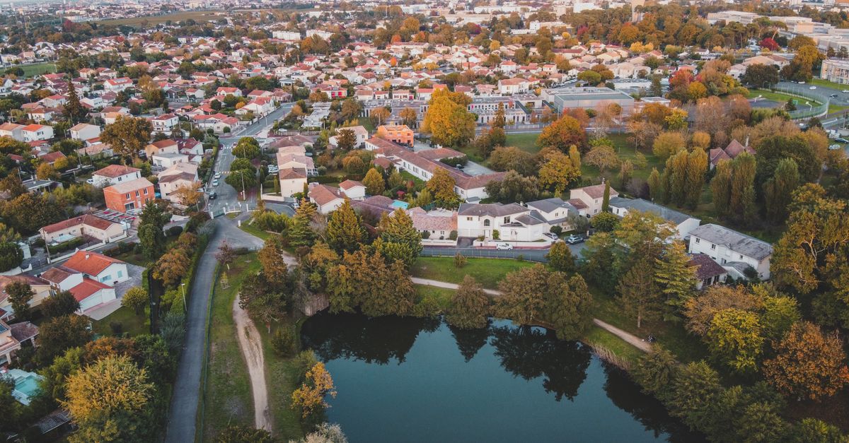 Scenic aerial view of Bordeaux, France showcasing residential areas and lush greenery during fall.