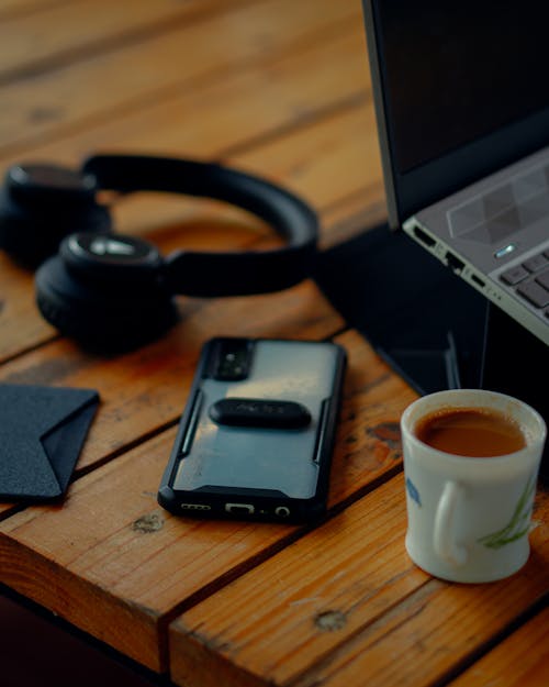 Gadgets and Coffee Drink in a Wooden Table Top 