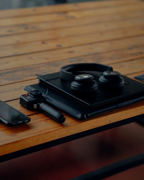 Free Close-Up Shot of Gadgets on a Wooden Table Stock Photo