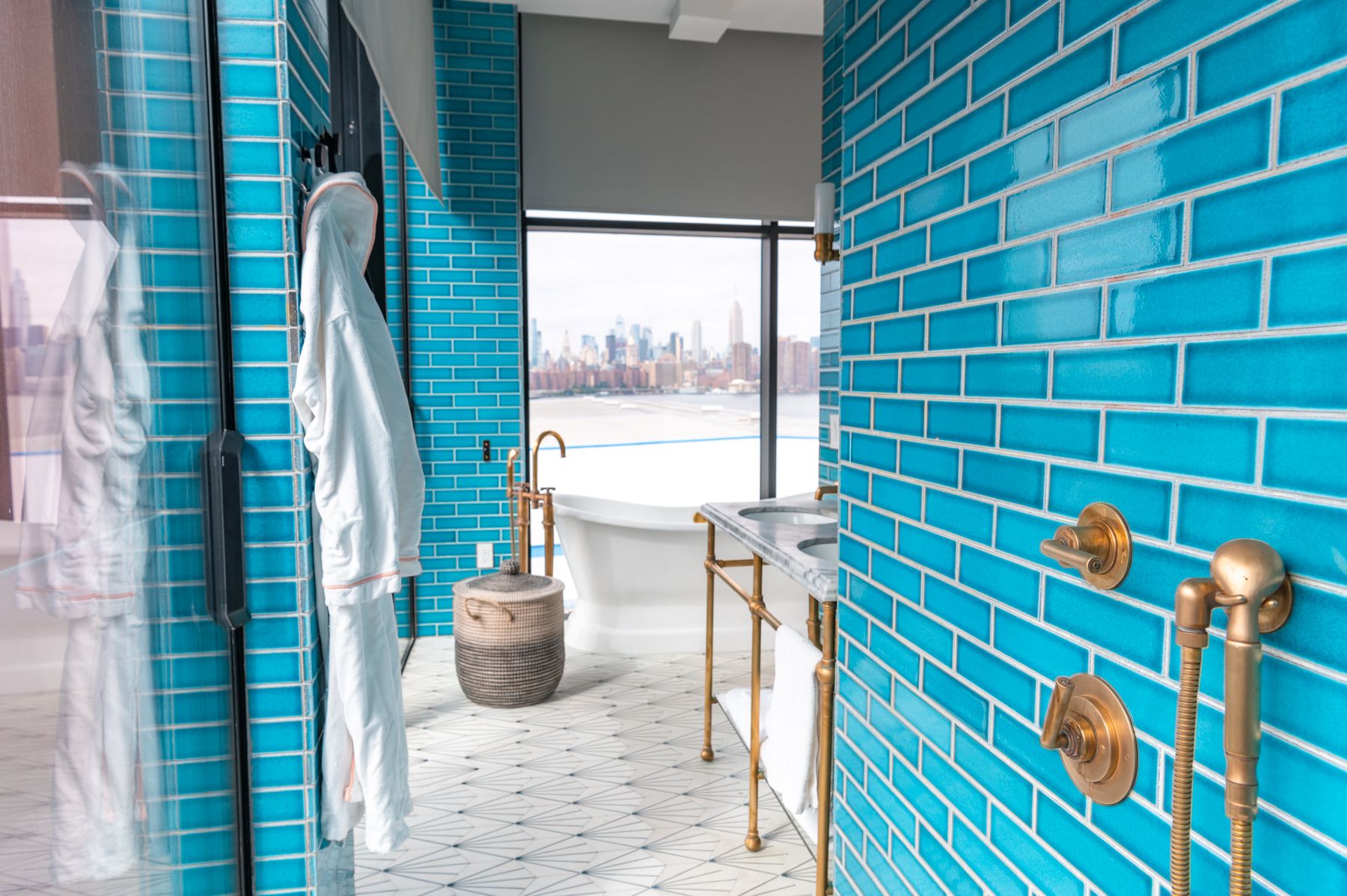 Blue interior with warm metal fittings and a wide city view