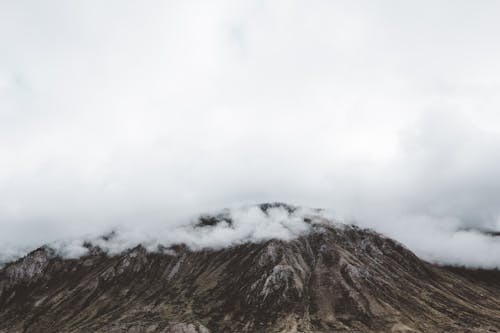 Free Rocky Mountain Peak covered in Clouds  Stock Photo
