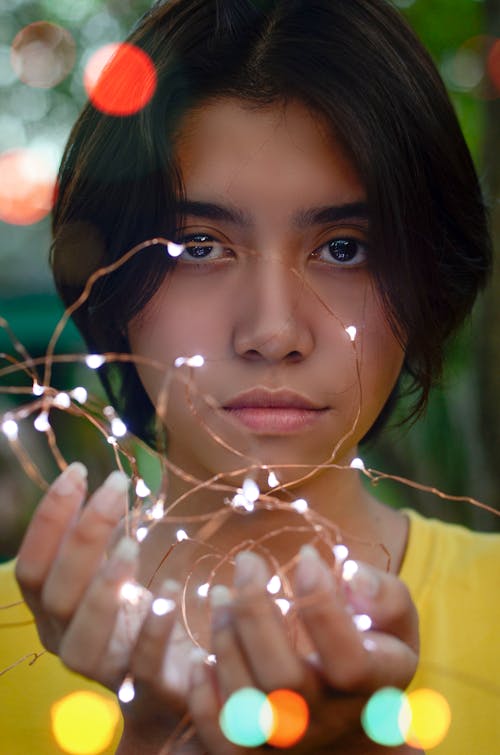 Girl Holding String Lights