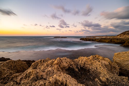 Cloudy Sky above a Rocky Beach