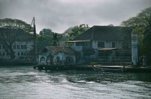 Free Charming waterfront scene in Kochi, India showcasing traditional architecture and tranquil waters. Stock Photo
