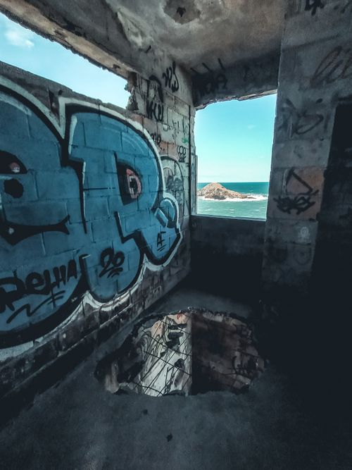 Free A desolate urban room with graffiti and ocean view through the window. Stock Photo