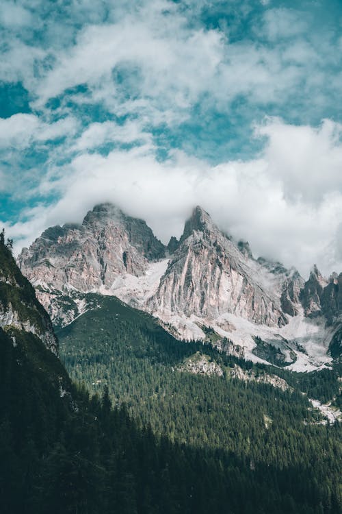 Green Trees on Mountains Under a Cloudy Sky