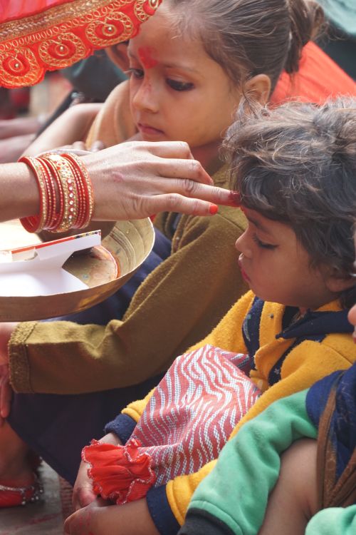 Free Children receiving traditional blessing during a cultural ceremony in India. Stock Photo