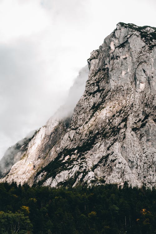 Gray and Black Rocky Mountain Under White Cloudy Sky