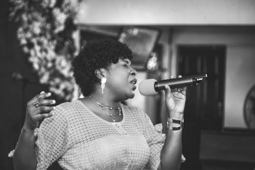 Grayscale Photography of a Woman Singing