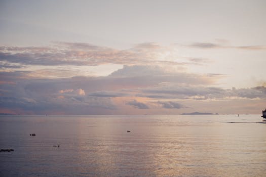 A peaceful seascape at dusk with tranquil waters and a colorful sky, perfect for relaxing visuals.