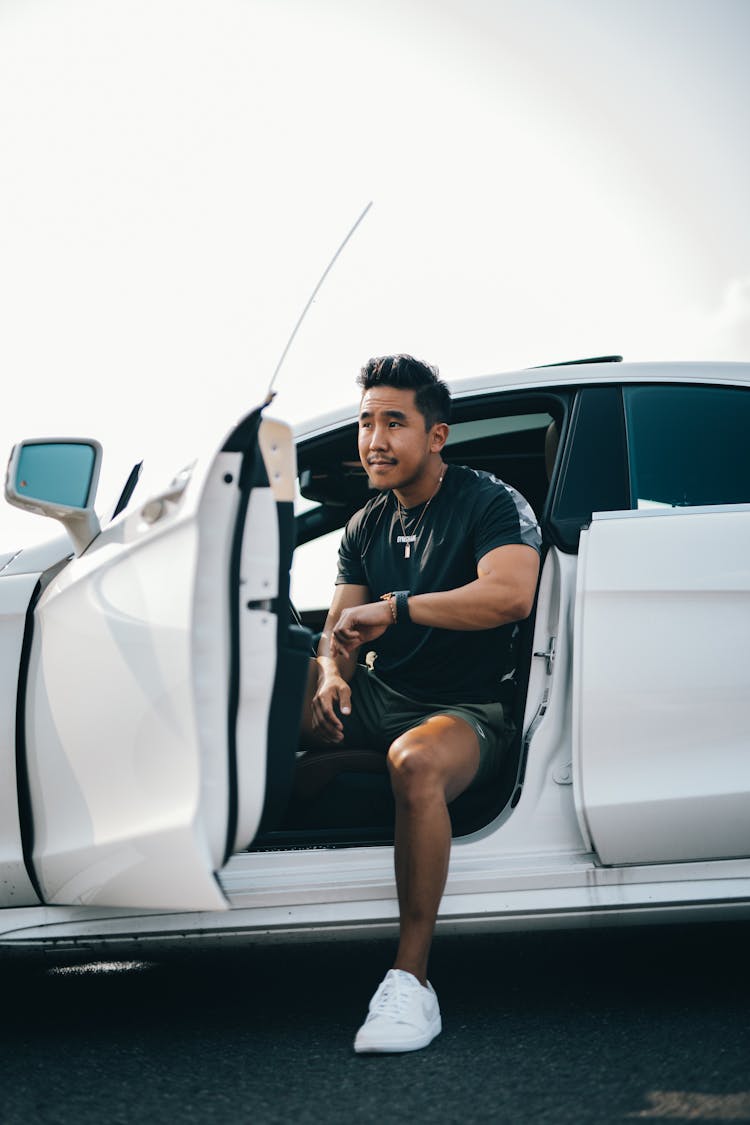 Young Man Getting Out From White Car