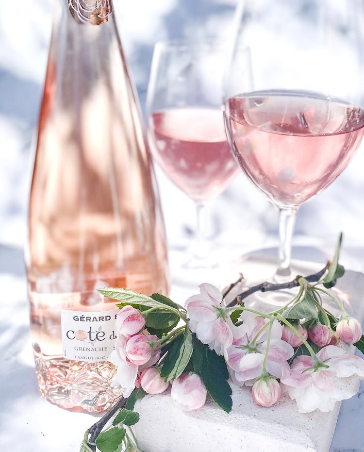 Pink Roses Beside Wine Bottle And Wine Glass