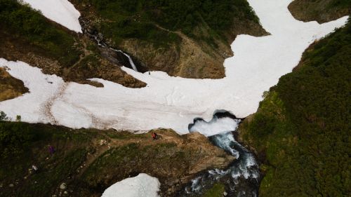 Free Breathtaking aerial view of melting snow and river in Kamchatka highlands. Stock Photo
