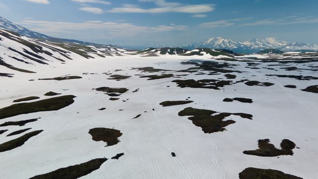 Breathtaking aerial view of the snowy mountain terrain in Kamchatka, Russia during winter.