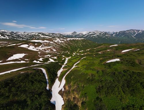 Free A stunning aerial view of the lush, snowy mountain range in Kamchatka, Russia. Stock Photo