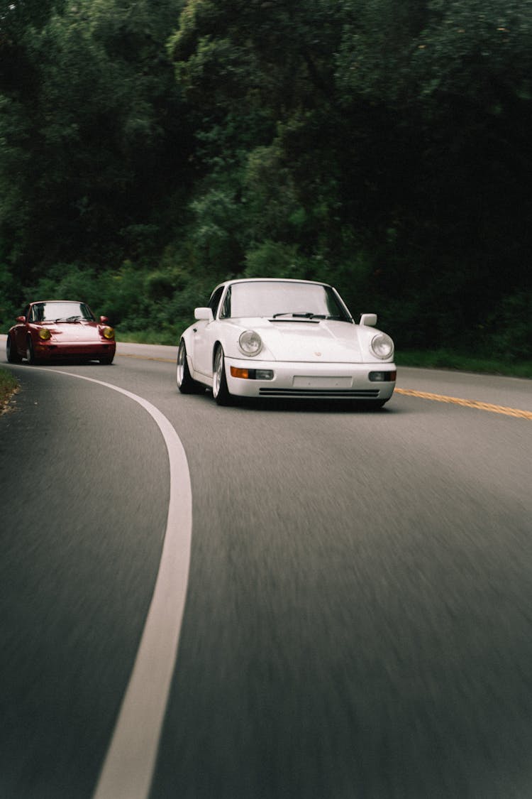 Porsche 911 Cars Driving On Concrete Road