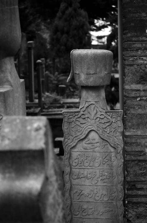 Black and White Photo of a Gravestone in a Cemetery