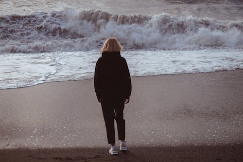 Free A Person Standing Beside the Beach Stock Photo