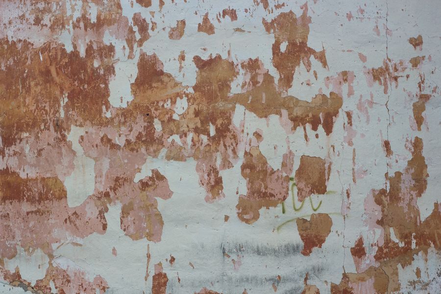 Worn, peeling wall before a colour change in Ely