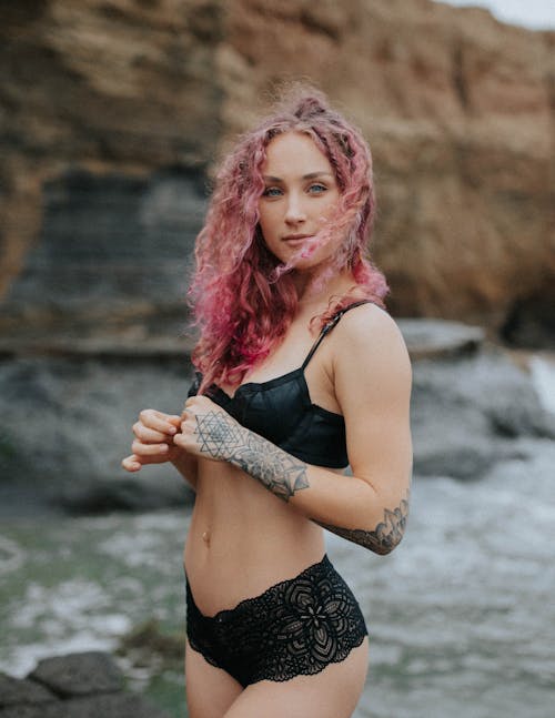 Woman with pink hair in black lingerie