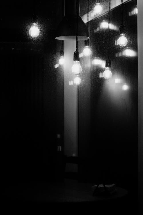 Grayscale Photo of Light Bulbs Illuminated