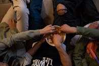 Various hands taking snacks from the bawl