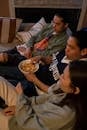 Friends sitting on the couch and eating snacks