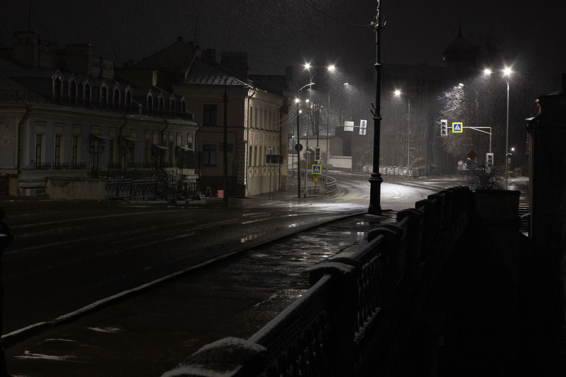 Quiet city street with empty pavements after rain.