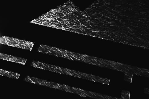 Abstract black and white image featuring geometric lines with a high contrast effect.